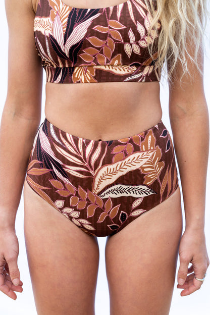Closeup of the Elation Boa surf bottoms and Elation Coco surf top, with the model facing to the camera.